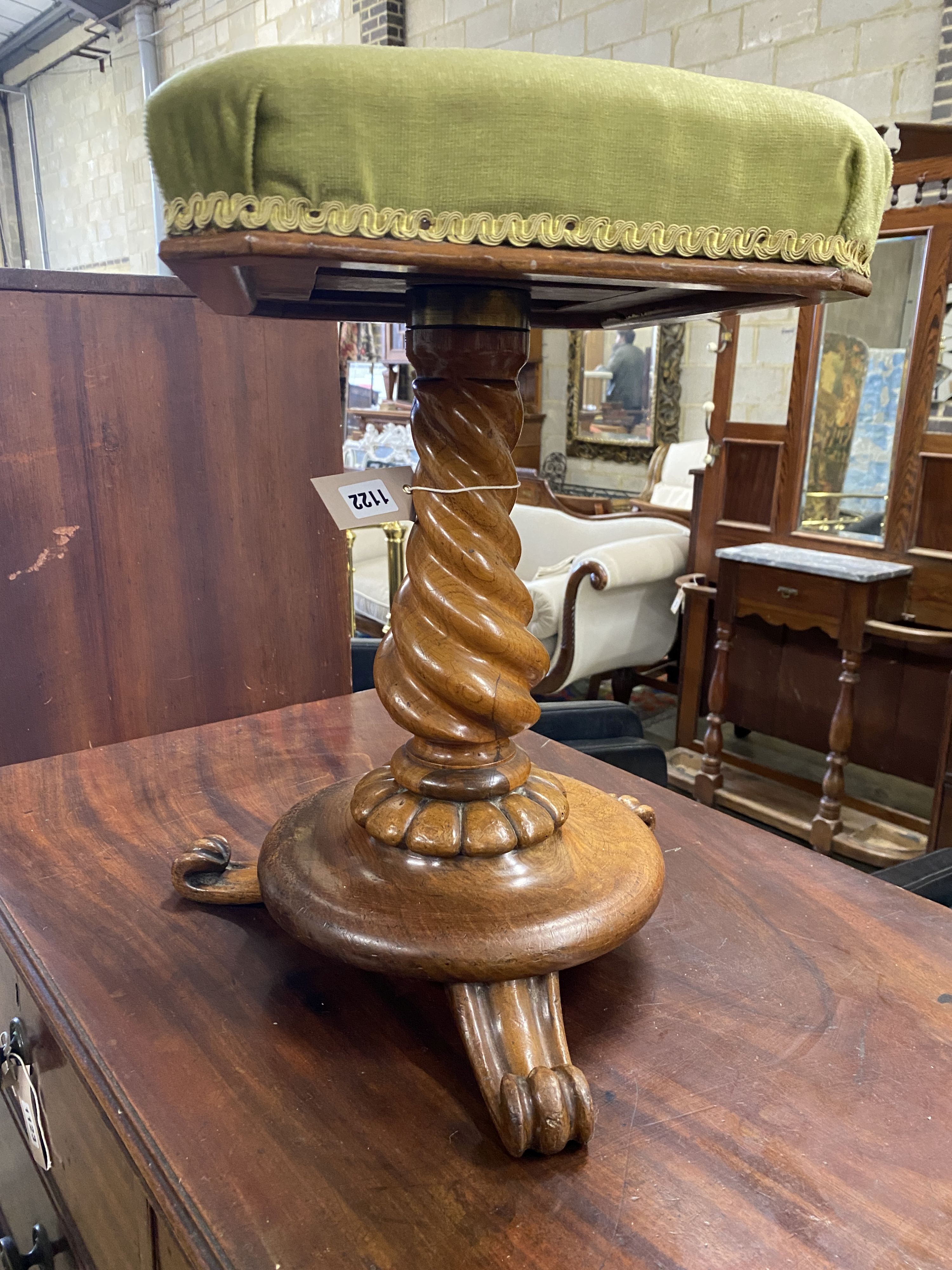 A Victorian turned walnut adjustable piano stool